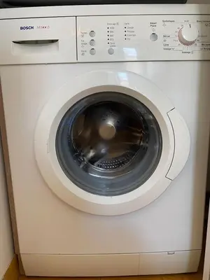 a white washing machine sitting in a room at Nice Port, French Riviera in Nice