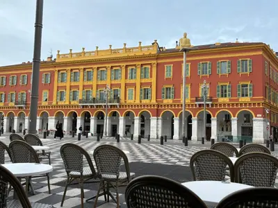 a building with tables and chairs in front of it at Nice Port, French Riviera in Nice