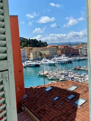 a view of a marina with boats in the water at Nice Port, French Riviera in Nice