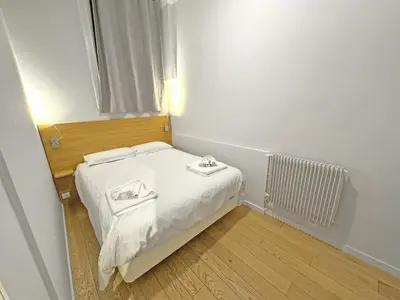 a small bedroom with a bed with two towels on it at PROMENADE HOLIDAY - ROCAMARE PROMENADE in Nice