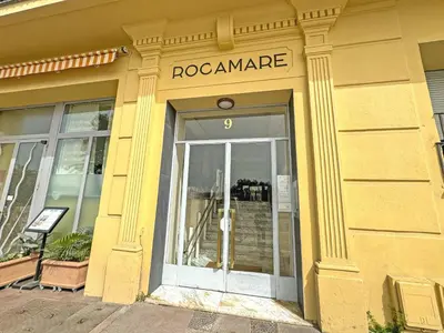 a yellow building with a pooamanca sign above a door at PROMENADE HOLIDAY - ROCAMARE PROMENADE in Nice