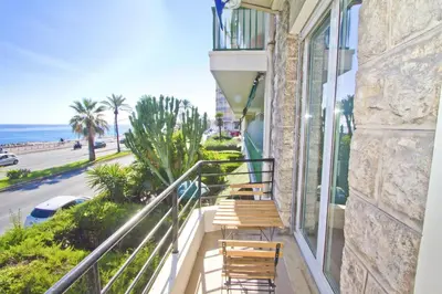 a balcony with chairs and a view of the ocean at PROMENADE HOLIDAY - SOLEMAR PROMENADE in Nice