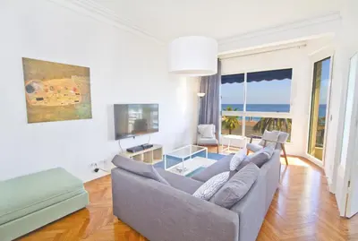 a living room with a couch and a television at PROMENADE HOLIDAY - SOLEMAR PROMENADE in Nice