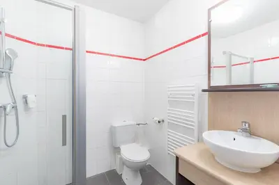 a bathroom with a toilet and a sink and a shower at Appart'City Classic Nice Acropolis in Nice