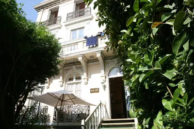 a white building with an umbrella in front of it at Villa Eden in Nice