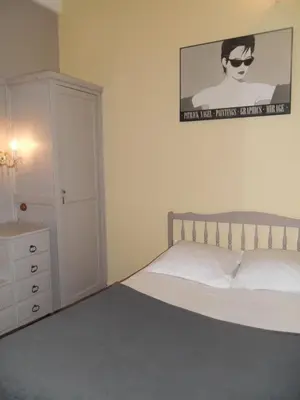 a bedroom with a bed and a dresser and a picture at Villa Eden in Nice
