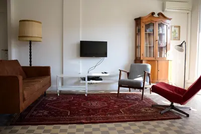 a living room with a couch and two chairs and a television at Les Gérardines by EnjoyNice, 3-room with Airco and balcony in Nice