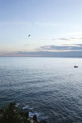 a boat in the middle of a large body of water at ANGLE DROIT- LOFT CHARMANT ET ATYPIQUE, CLIMATISATION, Vieux-Nice in Nice
