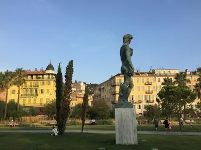 a statue in a park in front of a building at Chez Kari-top location in charming old town in Nice