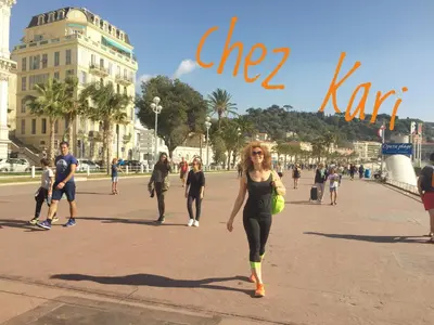 a woman walking down a street in a city at Chez Kari-top location in charming old town in Nice