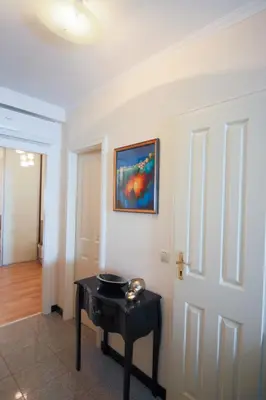 a room with a table and a painting on the wall at Sea view luxury apartment in Saint-Laurent-du-Var