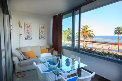 a living room with a view of the beach at Sea view luxury apartment in Saint-Laurent-du-Var