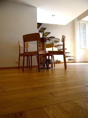 a dining room with a table and chairs on a wooden floor at Le Noble in Scenic Villefranche Sur Mer in Villefranche-sur-Mer