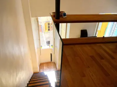 a hallway with a staircase and a window in a room at Le Noble in Scenic Villefranche Sur Mer in Villefranche-sur-Mer