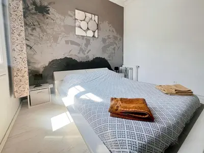 a bedroom with a bed with a towel on it at Proche promenade des anglais et de la mer in Nice