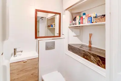 a bathroom with a sink and a mirror at Lovely Cosy Flat in Nice old town in Nice