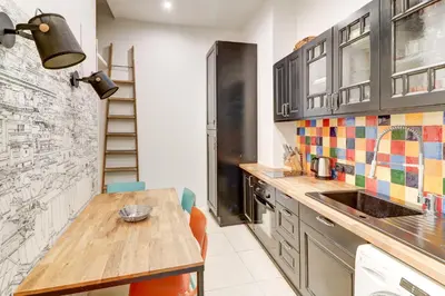 a kitchen with a wooden table and a sink at Lovely Cosy Flat in Nice old town in Nice