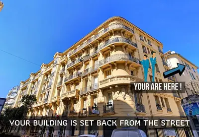 a building with a sign that reads your building is set back from the street at Nestor&Jeeves - LAVINIA - Central - Close sea in Nice