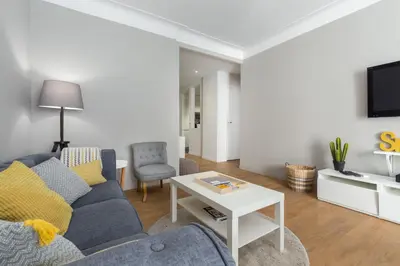 a living room with a couch and a table at Ultra Central Large 2 Bdr near Massena Square in Nice