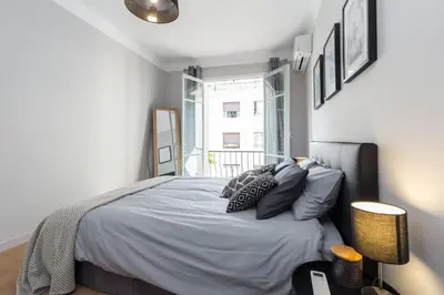 a bedroom with a bed with pillows and a window at Ultra Central Large 2 Bdr near Massena Square in Nice