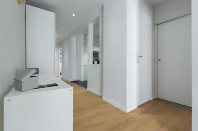 a hallway with white walls and a mirror at Ultra Central Large 2 Bdr near Massena Square in Nice