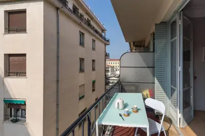 a balcony with a table and chairs on a building at Ultra Central Large 2 Bdr near Massena Square in Nice