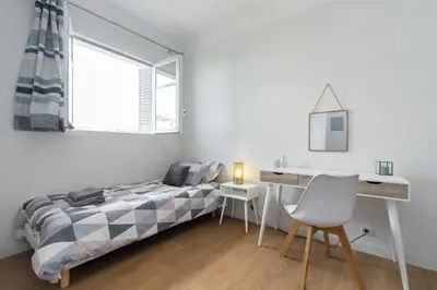 a bedroom with a bed and a desk and a window at Ultra Central Large 2 Bdr near Massena Square in Nice