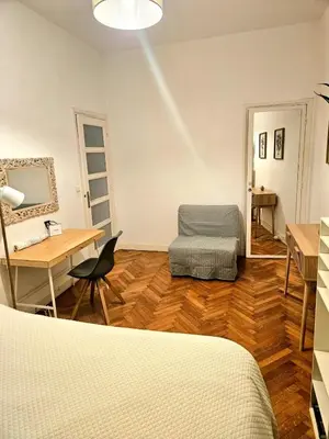 a room with a bed and a desk and a table at Seaflat in Nice in Nice