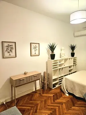 a room with a bed and a table and some plants at Seaflat in Nice in Nice