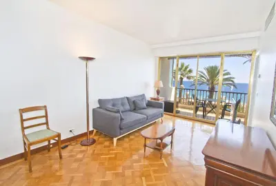 a living room with a couch and a table at PROMENADE HOLIDAY - ORIENT & SEA in Nice