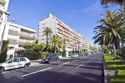 a street with cars parked on the side of a building at PROMENADE HOLIDAY - COSY SEA FRONT STUDIO in Nice