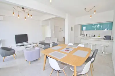 a living room with a wooden table and chairs at PROMENADE HOLIDAY - AZUR PROMENADE in Nice