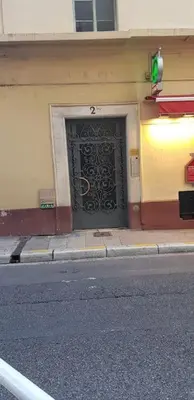 a building with a black door on the side of a street at Studette en plein cœur du Vieux Nice in Nice
