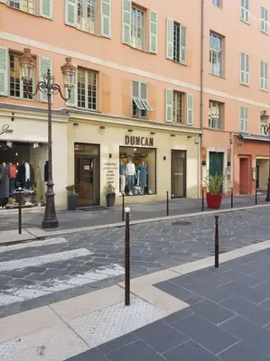 a street in front of a building with a store at Studette en plein cœur du Vieux Nice in Nice