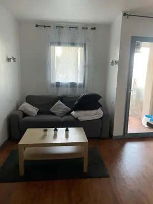a living room with a couch and a coffee table at Les Palmiers à 700m de la mer in Nice
