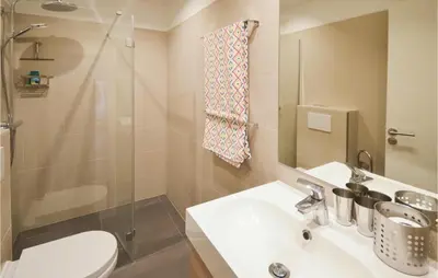 a bathroom with a sink and a toilet and a shower at Awesome Home In La Gaude With Kitchen in La Gaude