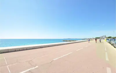 a beach with cars parked next to the ocean at Awesome Home In La Gaude With Kitchen in La Gaude