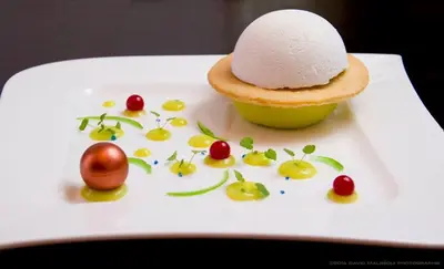 a white plate with a piece of bread and a dessert at B&B Villa sensorielle in Nice