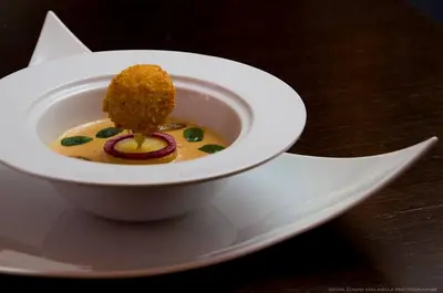 a bowl of food on a plate on a table at B&B Villa sensorielle in Nice