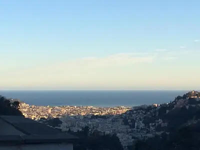 a view of a city at night with the ocean at B&B Villa sensorielle in Nice