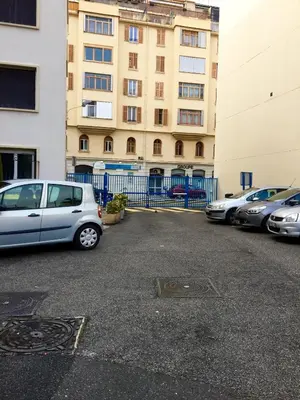 a parking lot with cars parked in front of a building at Studio 33 in Nice