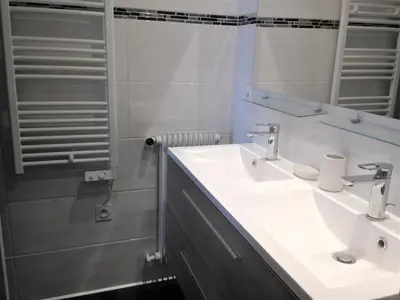 a white bathroom with a sink and a shower at Le Cros de Cagnes in Cagnes-sur-Mer