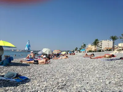a group of people laying on a beach at Le Cros de Cagnes in Cagnes-sur-Mer