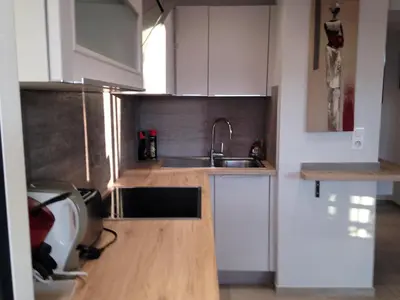 a small kitchen with white cabinets and a sink at Le Cros de Cagnes in Cagnes-sur-Mer