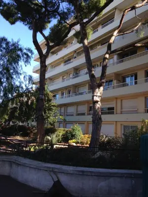 two trees in front of a building at Le Cros de Cagnes in Cagnes-sur-Mer