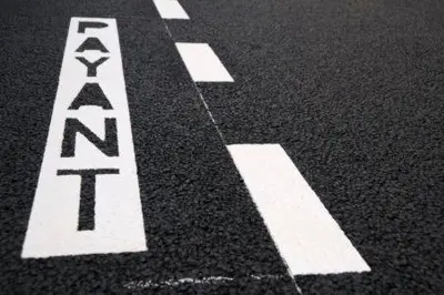 a white sign on the floor of a street at Hotel Marcellin in Beaulieu-sur-Mer