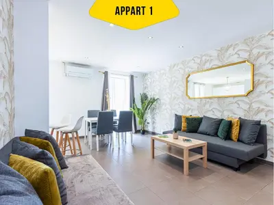 a living room with a couch and a table at CASA REINE JEANNE- ideal groups & family -CENTRAL near train station - PARKING - New&CONFORT-AC in Nice