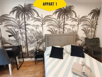 a bedroom with a bed with palm trees on the wall at CASA REINE JEANNE- ideal groups & family -CENTRAL near train station - PARKING - New&CONFORT-AC in Nice