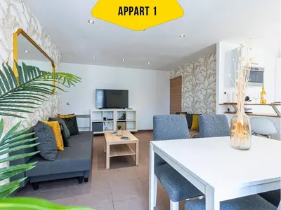 a living room with a white table and chairs at CASA REINE JEANNE- ideal groups & family -CENTRAL near train station - PARKING - New&CONFORT-AC in Nice