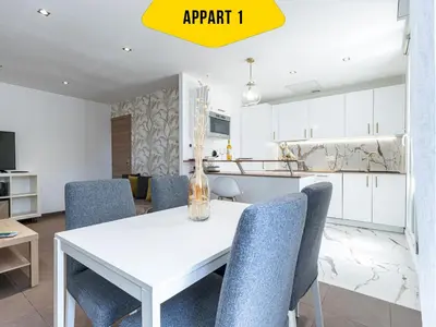 a dining room with a white table and blue chairs at CASA REINE JEANNE- ideal groups & family -CENTRAL near train station - PARKING - New&CONFORT-AC in Nice